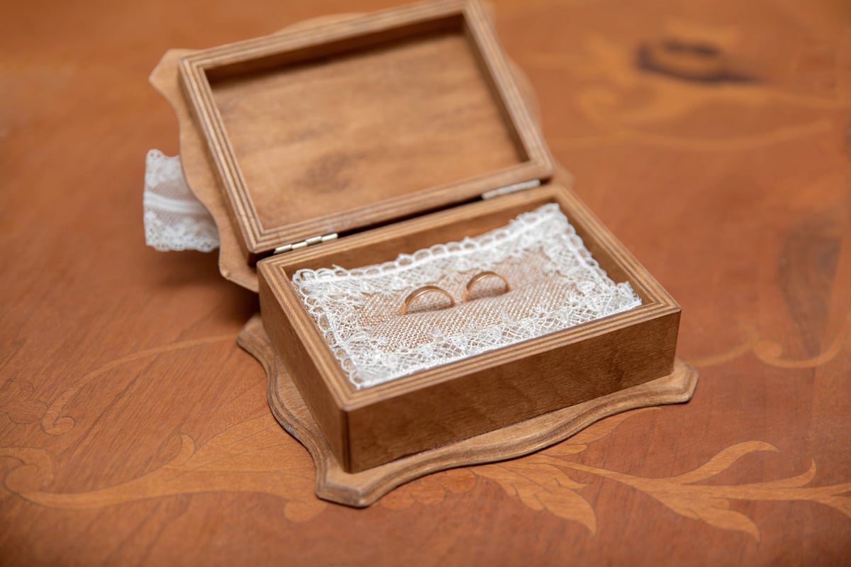 Wooden ring box with wedding rings inside
